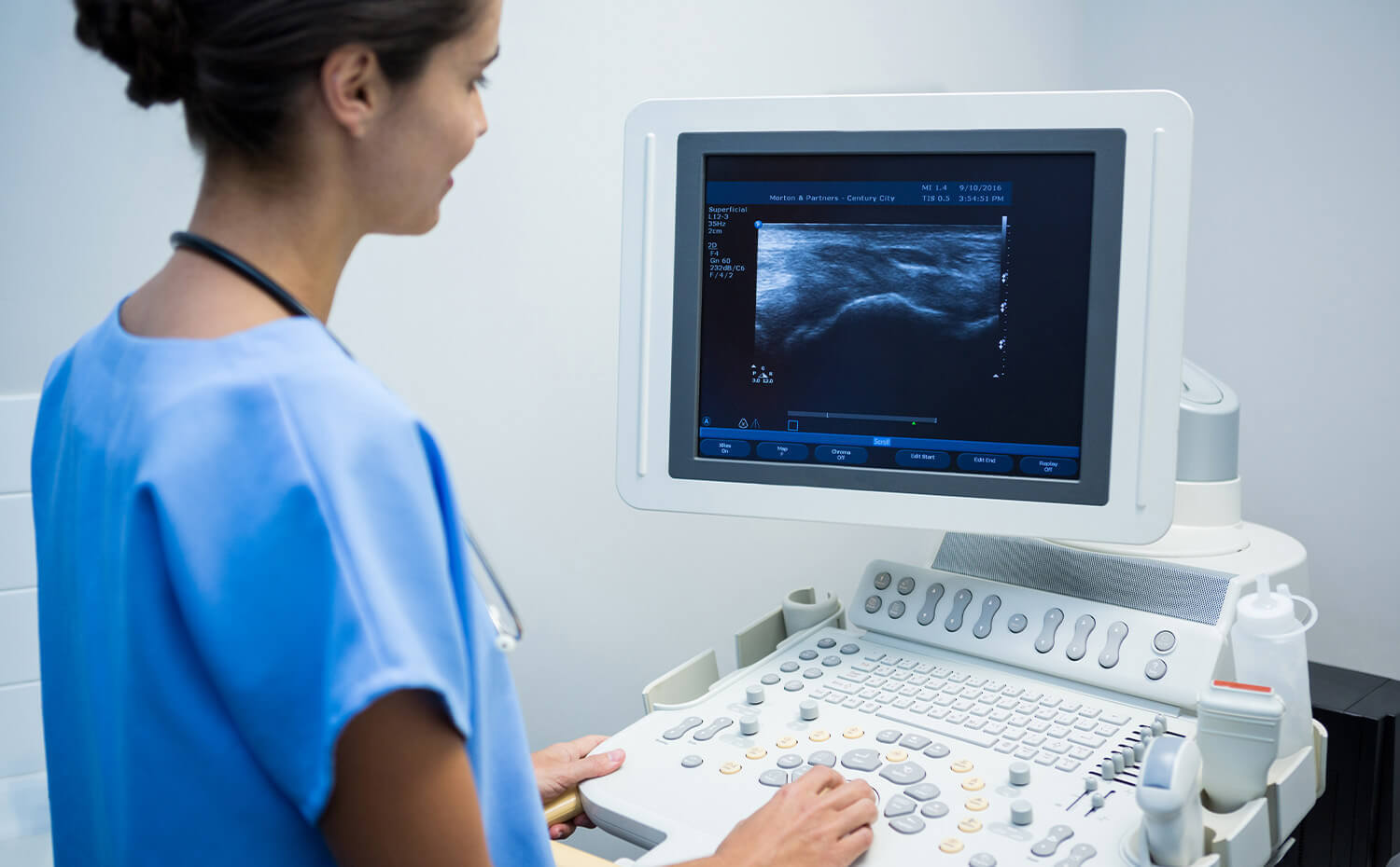 A technician looking at a diagnostic scan of a musculoskeletal ultrasound.
